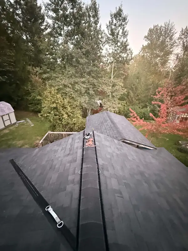 Finished dark architectural shingle roof with new ridge vent