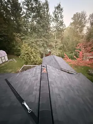 Finished dark architectural shingle roof with new ridge vent