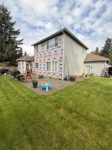 House wrap going up on the back of a two-story home