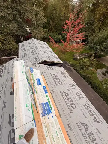 Underlayment and shingle bundles on a roof in fall