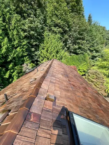 Cedar shake roof with skylight before work