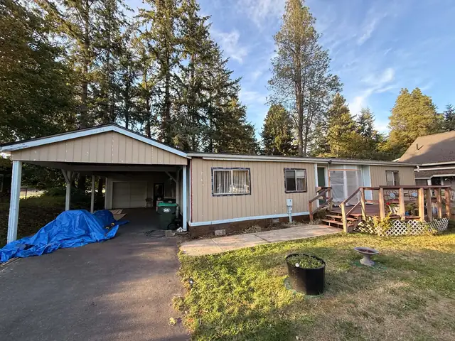 Single-story home with siding work underway