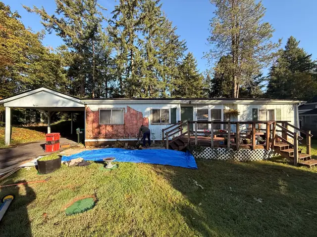 Old siding removed, insulation exposed