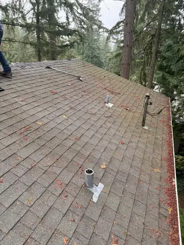 Old shingle roof with vents before tear-off